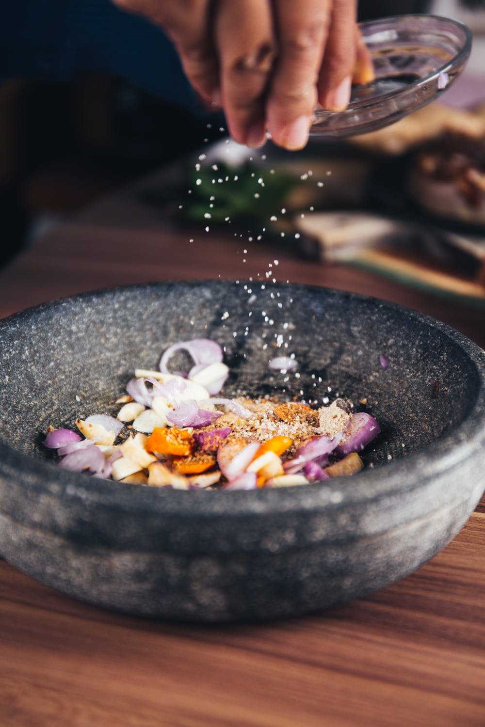 person pouring salt on bowl